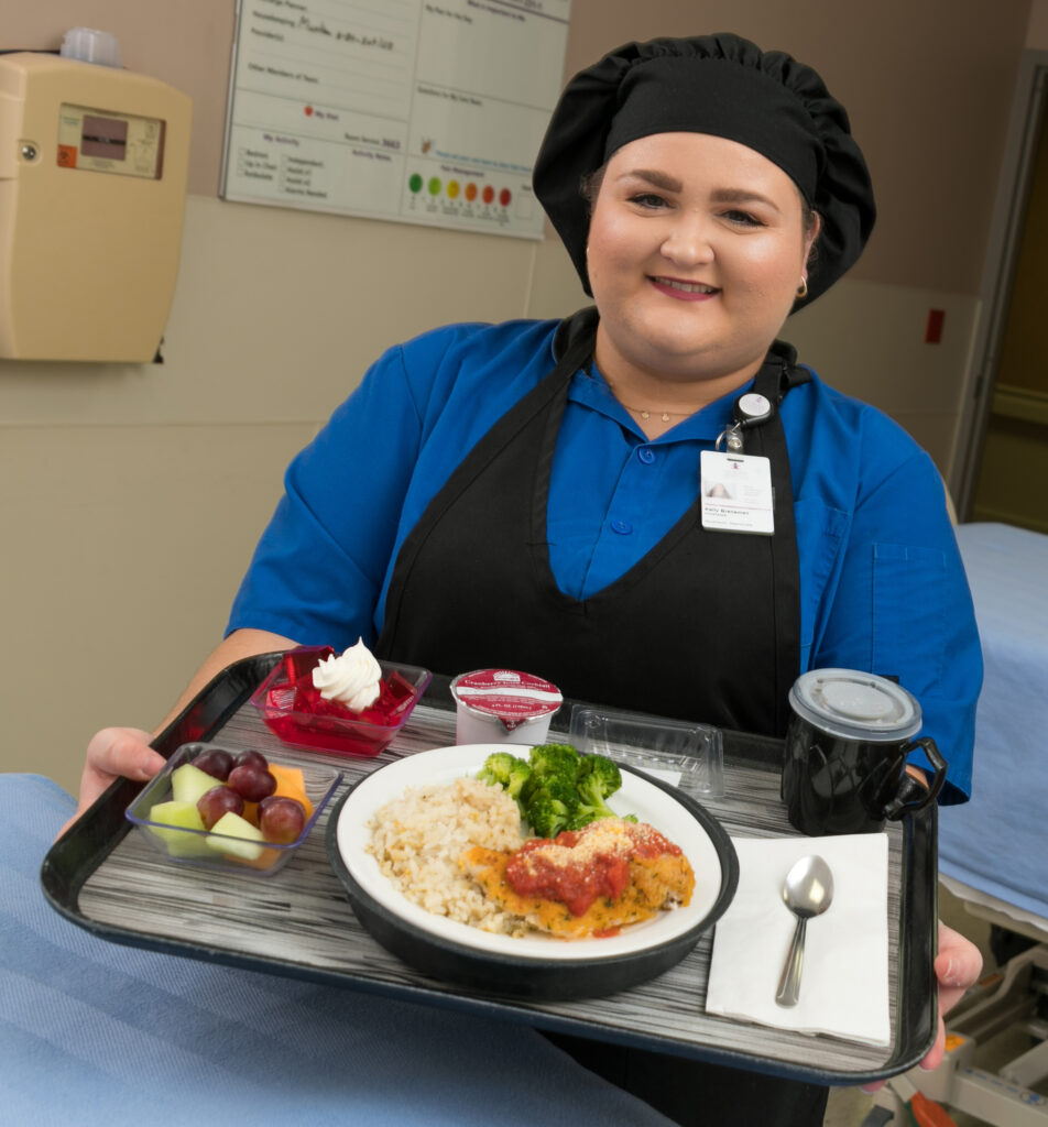 Chef holding tray of food
